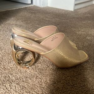 Brand New, Never Worn, Gold Shoe with unique heel!